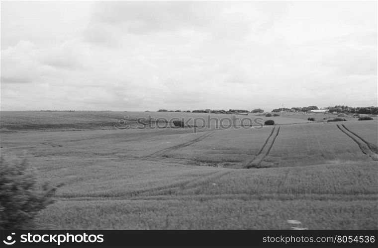 English country landscape. English countryside seen from a train near Liverpool, with selective focus on the horizon and motion blur on the foreground in black and white