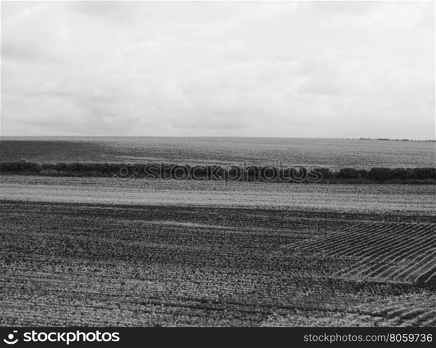 English country landscape. English countryside seen from a train near Liverpool, with selective focus on the horizon and motion blur on the foreground in black and white