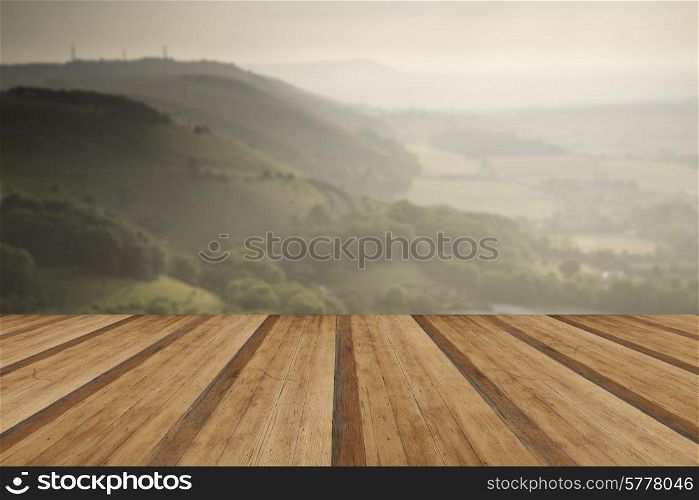 English countryside landscape during late Summer afternoon with dramatic sky and lighting with wooden planks floor