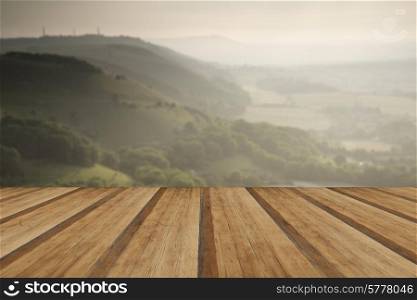 English countryside landscape during late Summer afternoon with dramatic sky and lighting with wooden planks floor