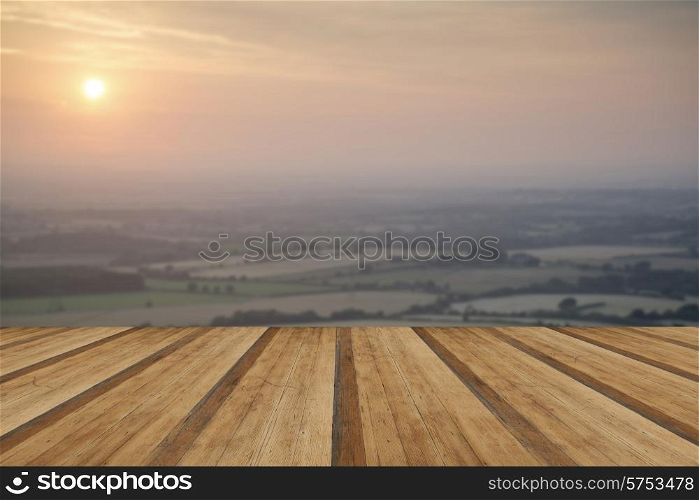 English countryside landscape during late Summer afternoon with wooden planks floor