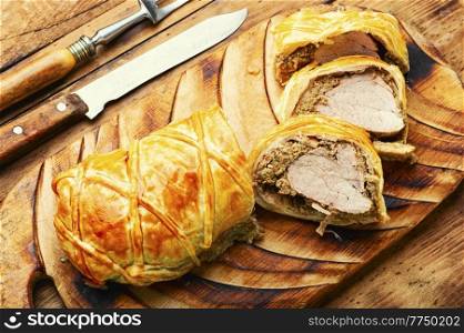 English dish of beef tenderloin in puff pastry stuffed with mushrooms. Wellington Meat. Wellington pork, pork tenderloin baked with mushrooms in puff pastry.