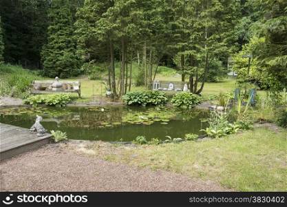 english garden with pond bech water trees and flowers