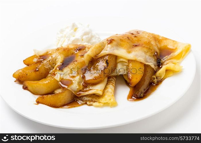 English-style pancakes filled with caramelised pears, topped with light caramel sauce and served with yoghurt.