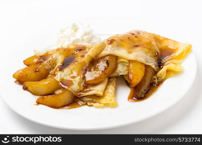 English-style pancakes filled with caramelised pears, topped with light caramel sauce and served with yoghurt.
