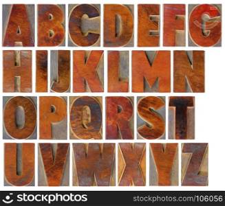English uppercase alphabet set - a collage of 26 isolated antique wood letterpress printing blocks with a digital painting effect