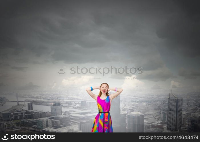 Enjoy silence. Young woman closing her ears with palms and enjoying the silence