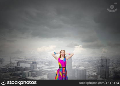 Enjoy silence. Young woman closing her ears with palms and enjoying the silence