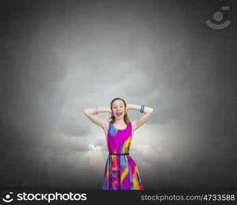 Enjoy silence. Young woman closing her ears with palms and enjoying the silence