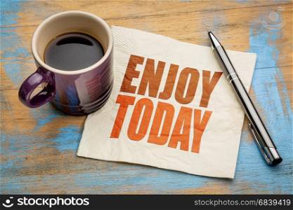 Enjoy today inspirational word abstract on a napkin with a cup of espresso coffee