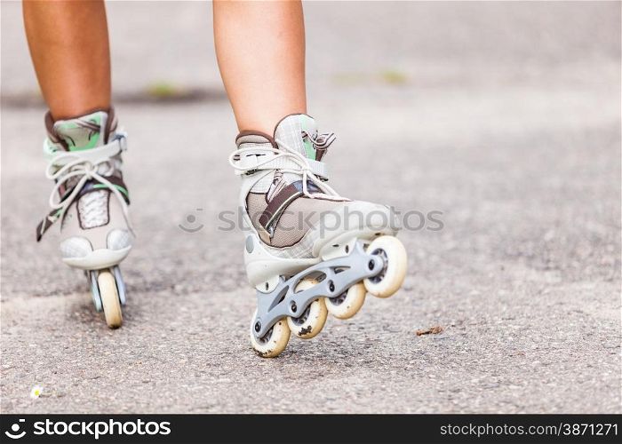Enjoying roller skating rollerblading on inline skates sport in park. Outdoor activities. Part of human legs in sport shoes.