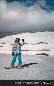 Enjoying Snowboarding. Active Woman Looking Away in High Snowy Mountains. Spending Winter Vacation on Ski Resort. Happy Sportive Lifestyle.. Winter Vacation on Ski Resort