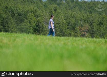 Enjoying the nature and life. Young woman arms raised enjoying the fresh air in green nature