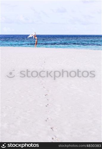 Enjoying vacation on the beach, cute girl jumping, carefree female wearing white bikini, young woman having fun on the sea, happy active girl