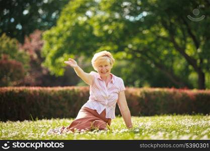 Enjoyment. Positive Emotions. Outgoing Old Woman Resting on Grass