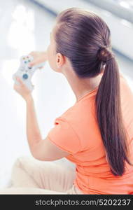 entertainment, home and internet - woman with joystick playing video games. woman with joystick playing video games