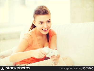 entertainment, home and internet - woman with joystick playing video games