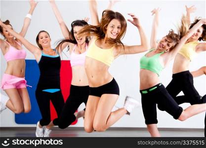 Enthusiastic group of women having fun during aerobics class.