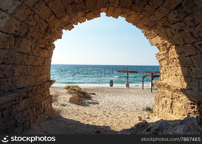 Entrance to the sand beach through the arch of aqueduct near Caesarea, Israekl
