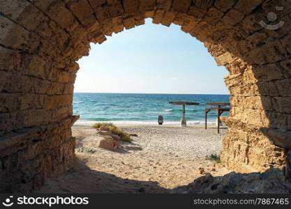 Entrance to the sand beach through the arch of aqueduct near Caesarea, Israekl