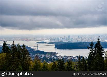 Entrance to Vancouver Harbour and Lions Gate Bridge with surrounding city in distance in Vancouver, BC, Canada.