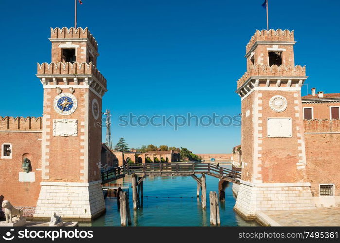 Entrance to Venetian Arsenal with clock and towers. Venice, Italy