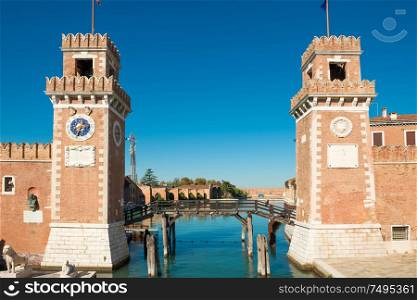 Entrance to Venetian Arsenal with clock and towers. Venice, Italy