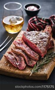 Entrecote. Steak on the bone. Rib eye. Tomahawk steak on the on a cutting board with rosemary. Roasting - Rare.