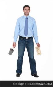 Entrepreneur holding trowel and a brick