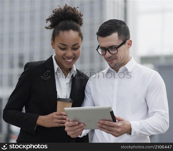 entrepreneurs looking ipad medium shot