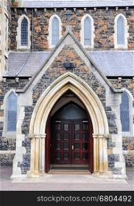 Entry into the unknown church with wooden doors.