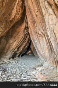 entry to the natural, 83 feet long Tusher tunnel under sandstone rock in the Moab area, Utah