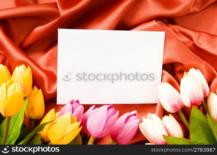 Envelope and flowers on the satin background