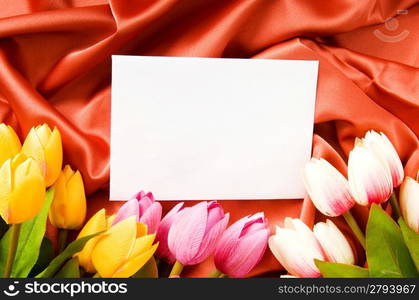 Envelope and flowers on the satin background