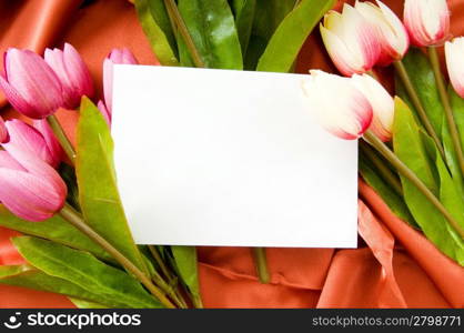 Envelope and flowers on the satin background