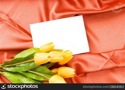Envelope and flowers on the satin background