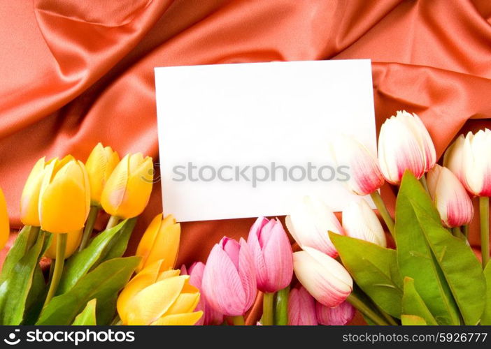 Envelope and flowers on the satin background