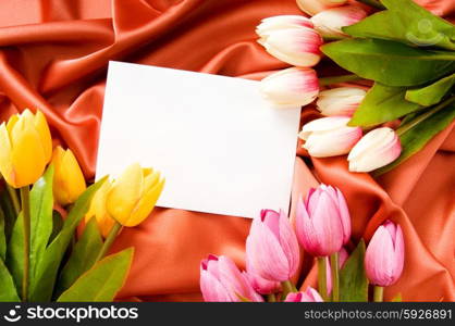 Envelope and flowers on the satin background