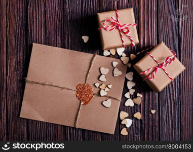 envelope and presernts on the wooden table