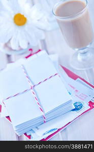 envelopes and pen on the wooden table