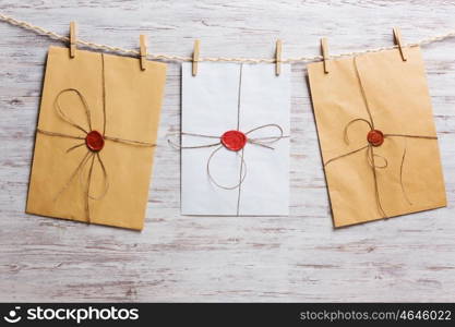 Envelopes on rope. Old envelopes hanging on rope fixed with clothes peg