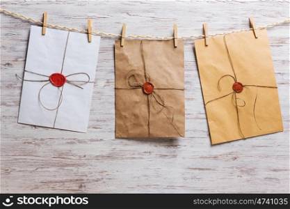 Envelopes on rope. Old envelopes hanging on rope fixed with clothes peg
