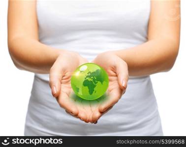 environment and technology concept - woman hands holding green sphere globe