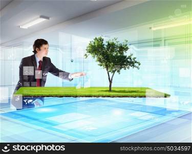 Environmental problems and high-tech innovations. Image of young businessman touching icon of high-tech picture of environment concept