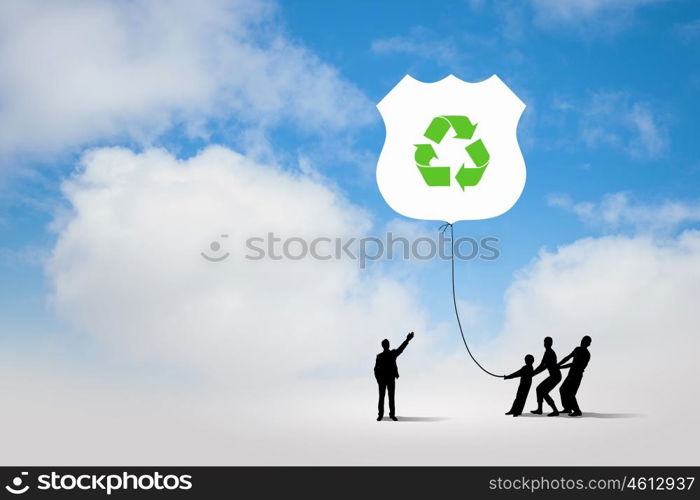 Environmental protection. Silhouettes of people pulling balloon with recycle sign