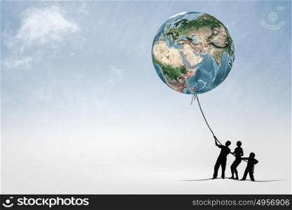 Environmental protection. Silhouettes of people pulling Earth plane with rope. Elements of this image are furnished by NASA
