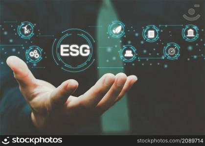 Environmental, social, and governance (ESG) investment Organizational growth that is sustainable is a business idea. A man&rsquo;s hand touches the ESG word on a virtual screen.