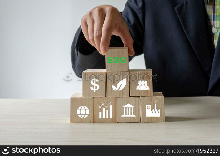 Environmental, social, and governance (ESG) investment Organizational growth. Wooden cube with symbol of esg concept