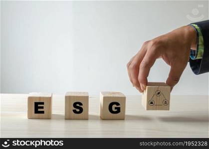 Environmental, social, and governance (ESG) investment Organizational growth. Wooden cube with symbol of esg concept