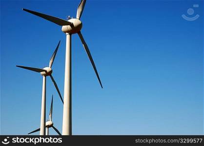Eolic power generator: windmills over blue sky